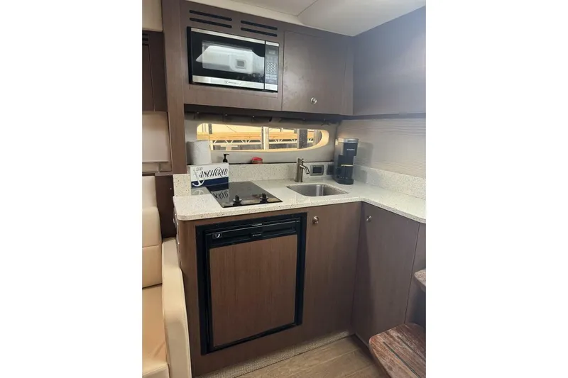  Yacht Photos Pics 2016 Sea Ray 350 Sundancer galley with microwave, sink, and compact fridge.