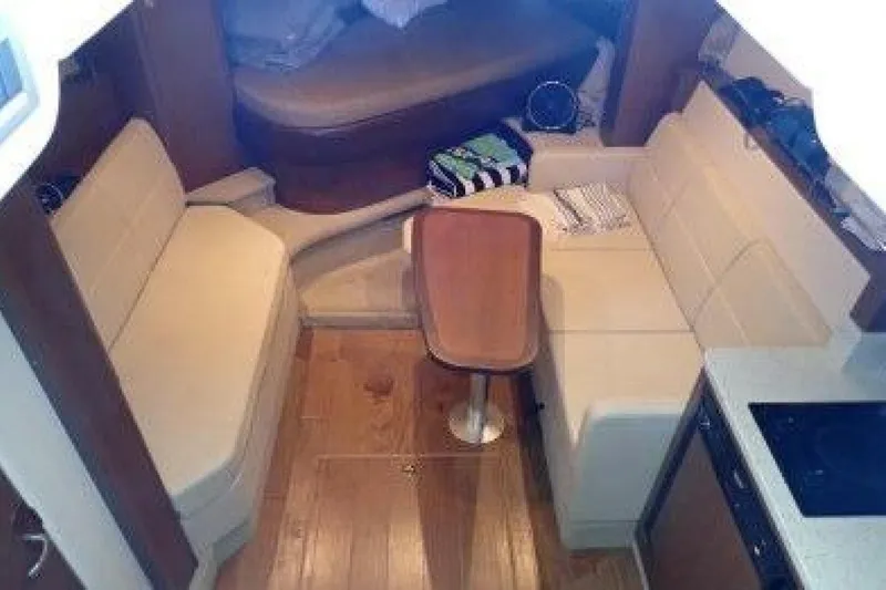  Yacht Photos Pics Interior of 2016 Sea Ray 350 Sundancer with beige seating and wooden flooring.