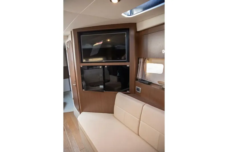  Yacht Photos Pics Interior of 2016 Sea Ray 350 Sundancer with TV and beige seating.