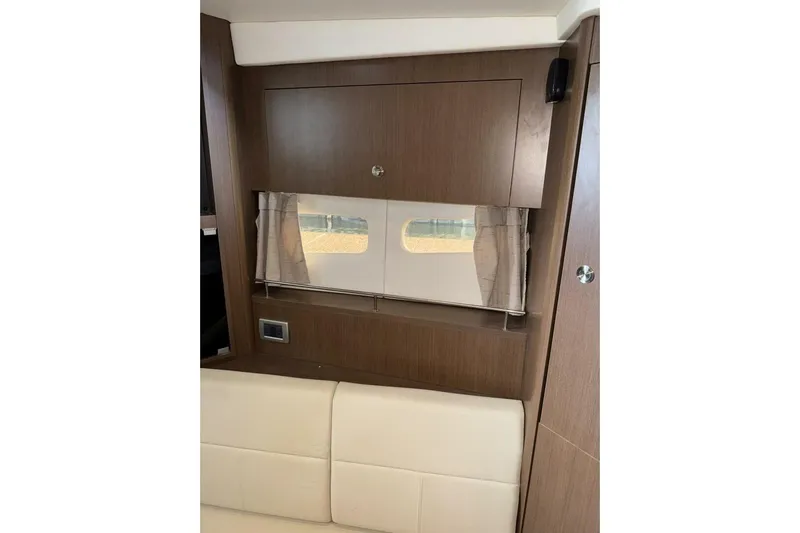  Yacht Photos Pics Interior of 2016 Sea Ray 350 Sundancer with wood paneling and window.