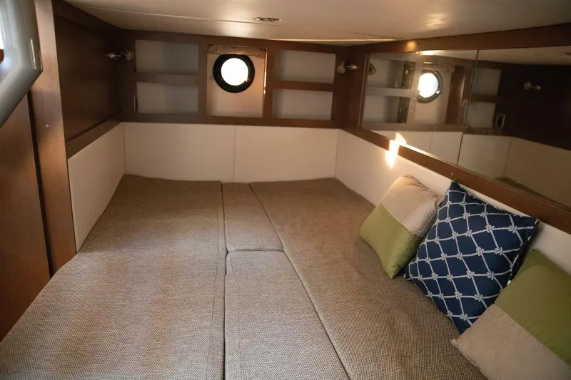  Yacht Photos Pics Cozy cabin interior of 2016 Sea Ray 350 Sundancer with cushions and porthole.