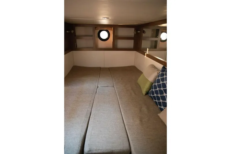  Yacht Photos Pics Interior cabin of 2016 Sea Ray 350 Sundancer with cozy bedding and pillows.