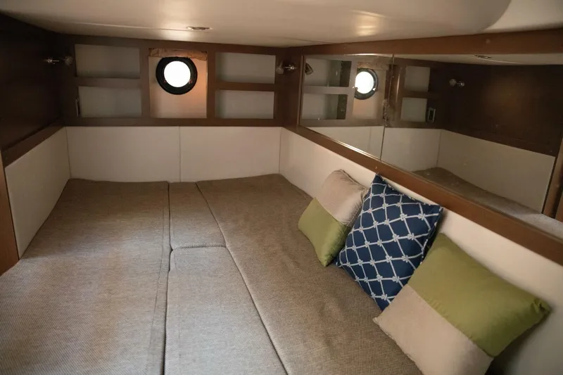  Yacht Photos Pics 2016 Sea Ray 350 Sundancer cabin interior with cozy bedding and decorative pillows.