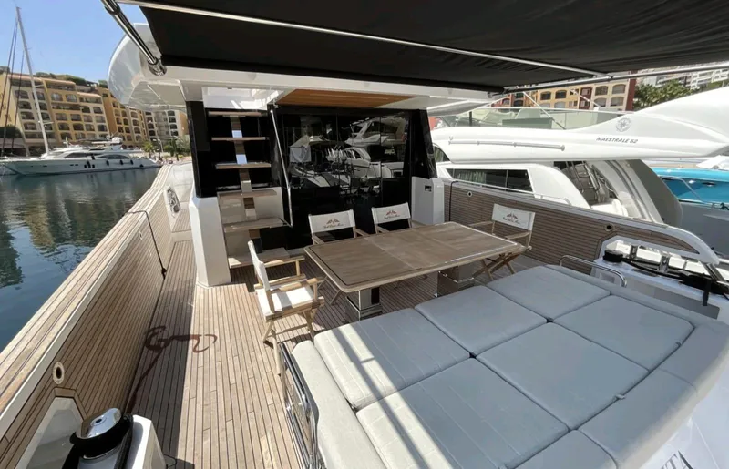  Yacht Photos Pics Luxurious 2021 Pardo Yachts E60 deck with seating and dining area in marina setting.