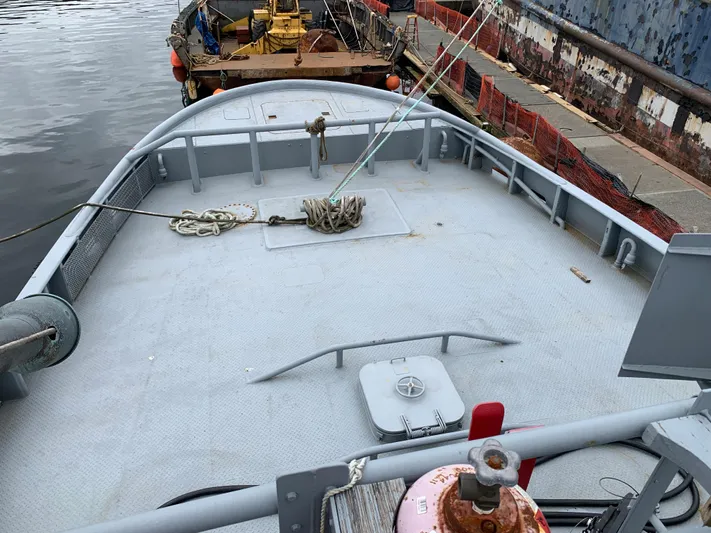  Yacht Photos Pics 1955 L-T 100 Steel Army Tugboat deck, docked at a harbor with ropes and equipment.
