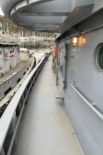  Yacht Photos Pics 1955 L-T 100 Steel Army Tugboat deck with railing and porthole, docked at marina.