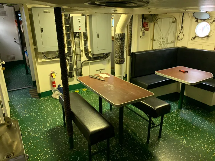  Yacht Photos Pics 1955 Tugboat L-T 100 Steel Army Tug interior with green flooring and dining area.