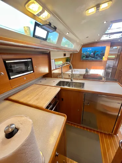  Yacht Photos Pics Modern kitchen interior of 2017 Catalina 425 yacht with wood finish and stainless steel sink.