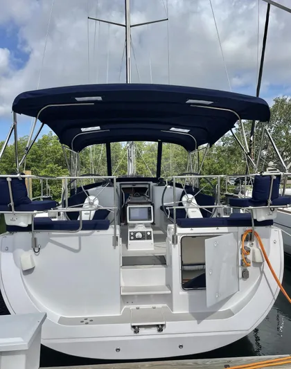  Yacht Photos Pics 2017 Catalina 425 sailboat with blue canopy, docked, featuring modern cockpit and navigation equipment.