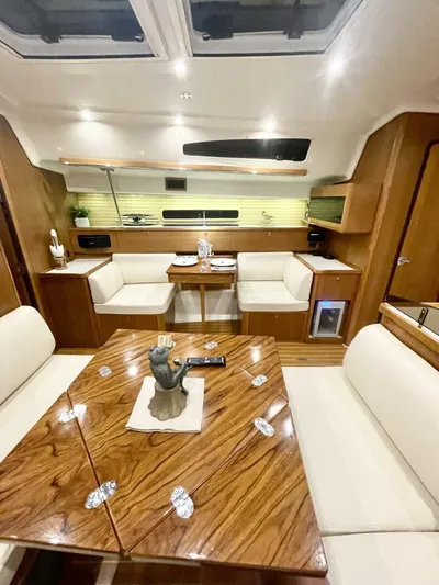  Yacht Photos Pics Luxurious interior of a 2017 Catalina 425 yacht with elegant wood finishes and plush seating.
