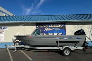2017 RH Boats 18 SH on trailer, parked outside a marine store.