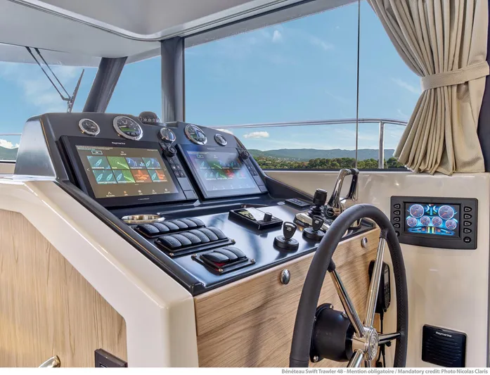 Demo Yacht Photos Pics Helm of 2025 Beneteau Swift Trawler 48 with modern navigation displays and controls.