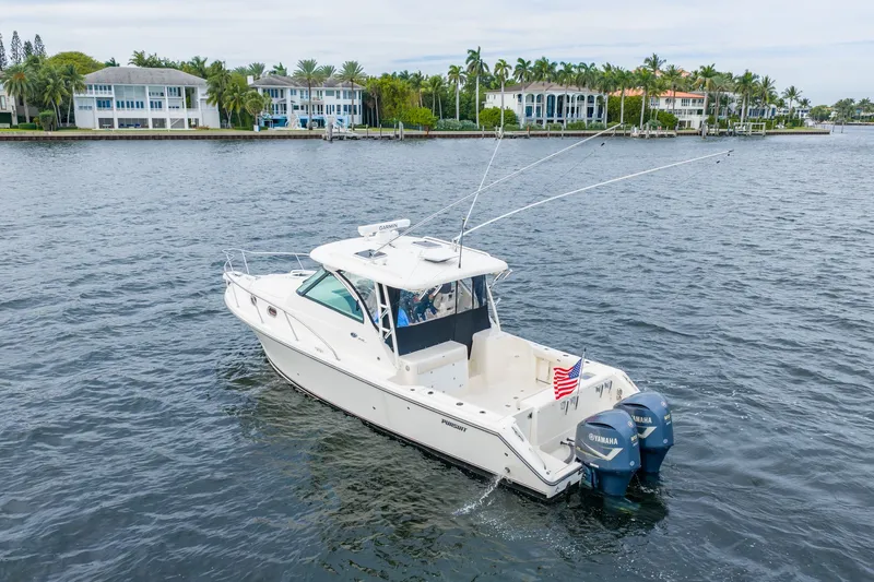  Yacht Photos Pics 2012 Pursuit OS 345 Offshore boat on calm water.