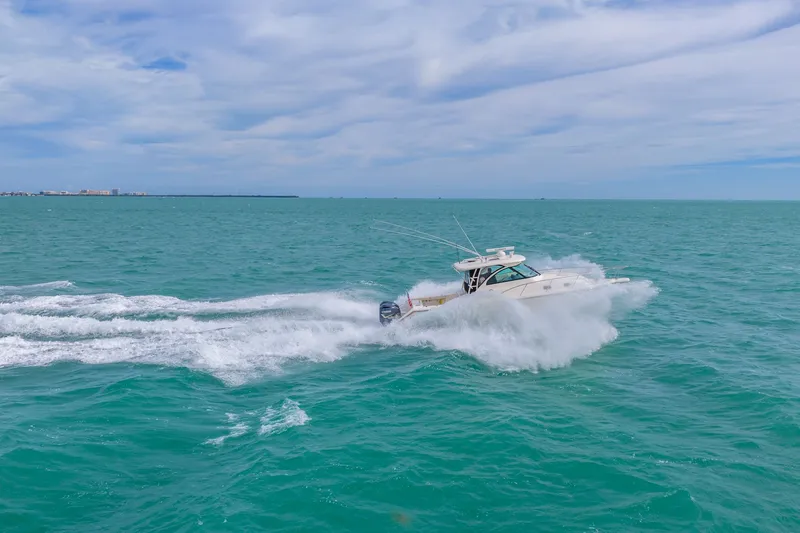  Yacht Photos Pics 2012 Pursuit OS 345 Offshore boat cruising on open sea.