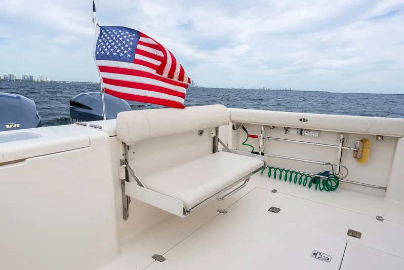  Yacht Photos Pics 2012 Pursuit OS 345 Offshore with American flag on the ocean.