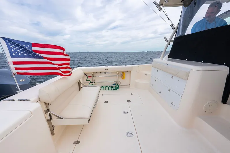  Yacht Photos Pics 2012 Pursuit OS 345 Offshore with American flag on the water.