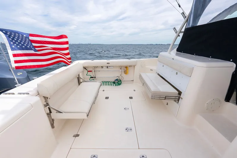  Yacht Photos Pics 2012 Pursuit OS 345 Offshore with American flag on open sea.