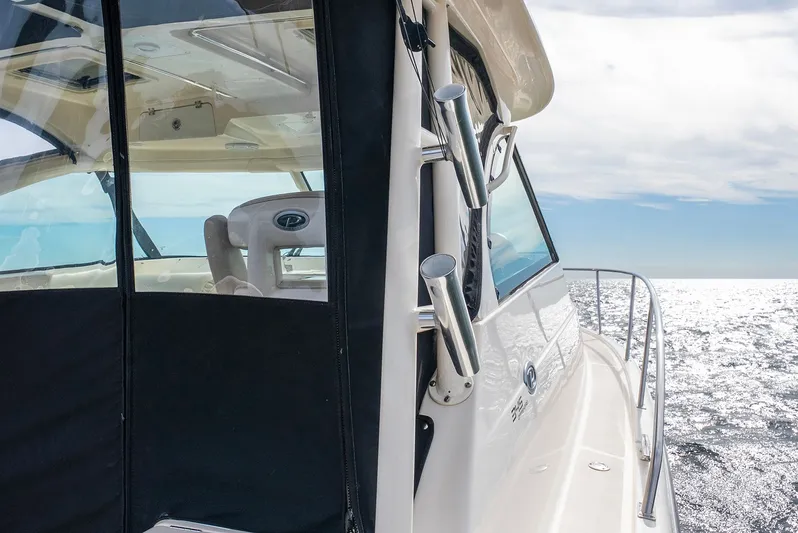  Yacht Photos Pics Pursuit OS 345 Offshore 2012 on open sea under sunny skies.