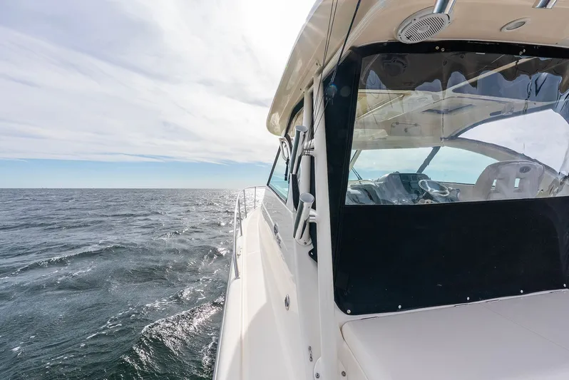  Yacht Photos Pics Pursuit OS 345 Offshore 2012 on open sea under sunny skies.