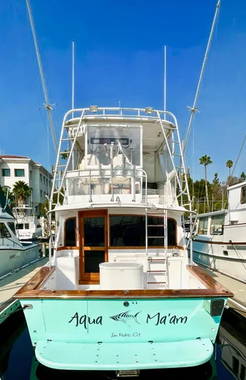 Aqua Ma'am Yacht Photos Pics 1986 Ocean Yachts 38 Super Sport docked, rear view with "Aqua Ma'am" name.