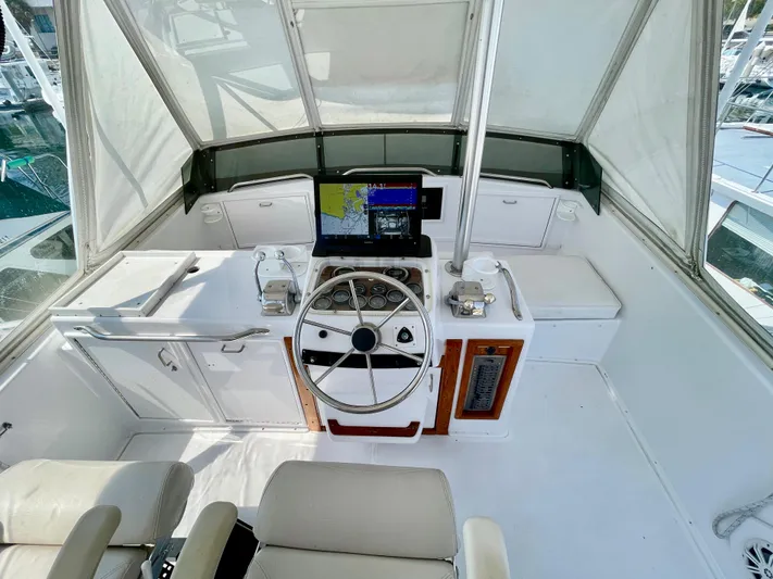 Aqua Ma'am Yacht Photos Pics Helm of 1986 Ocean Yachts 38 Super Sport with steering wheel and navigation equipment.