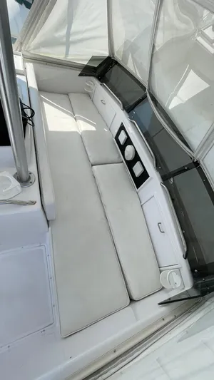 Aqua Ma'am Yacht Photos Pics 1986 Ocean Yachts 38 Super Sport interior with white seating and sleek design.