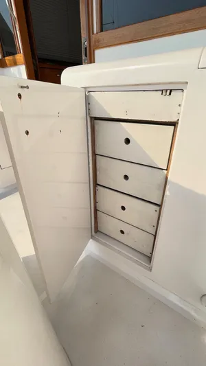 Aqua Ma'am Yacht Photos Pics Open storage cabinet with drawers on a 1986 Ocean Yachts 38 Super Sport.