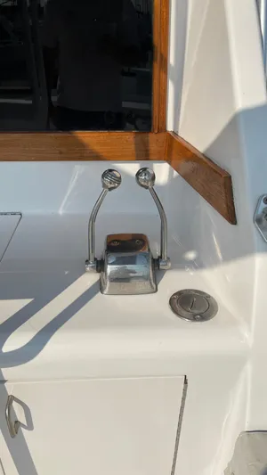 Aqua Ma'am Yacht Photos Pics 1986 Ocean Yachts 38 Super Sport boat controls with wooden trim and white surface.