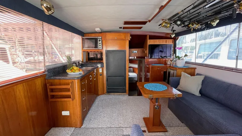 Aqua Ma'am Yacht Photos Pics Interior of a 1986 Ocean Yachts 38 Super Sport, featuring wood cabinetry and seating.