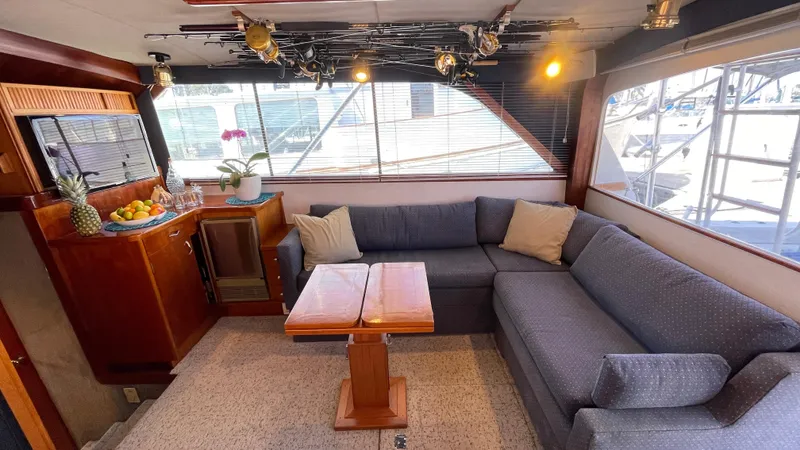 Aqua Ma'am Yacht Photos Pics Interior of 1986 Ocean Yachts 38 Super Sport with cozy seating and wooden table.