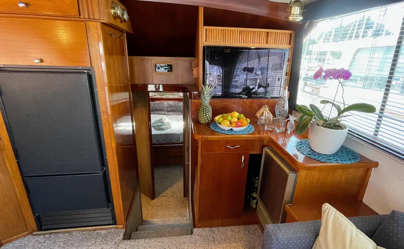 Aqua Ma'am Yacht Photos Pics Interior of 1986 Ocean Yachts 38 Super Sport with wood cabinetry and fruit display.