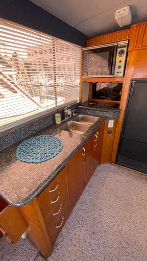 Aqua Ma'am Yacht Photos Pics 1986 Ocean Yachts 38 Super Sport kitchen with wood cabinets and granite countertops.