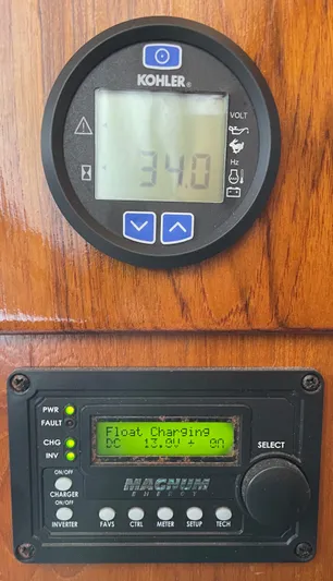 Aqua Ma'am Yacht Photos Pics Control panel on a 1986 Ocean Yachts 38 Super Sport, displaying voltage and charging status.