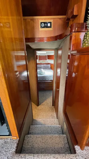 Aqua Ma'am Yacht Photos Pics Interior view of 1986 Ocean Yachts 38 Super Sport, featuring wooden paneling and carpeted stairs.