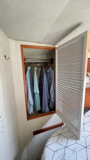 Aqua Ma'am Yacht Photos Pics Open closet with clothes inside on 1986 Ocean Yachts 38 Super Sport.