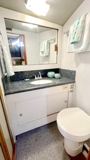 Aqua Ma'am Yacht Photos Pics Bathroom interior of 1986 Ocean Yachts 38 Super Sport with sink and toilet.