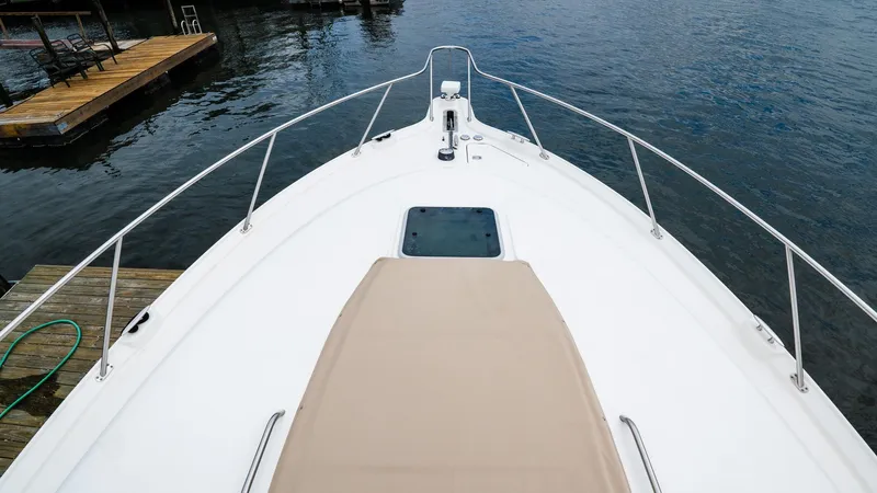  Yacht Photos Pics 2007 Tiara Yachts 4300 Sovran bow view with sunpad, docked on calm water.