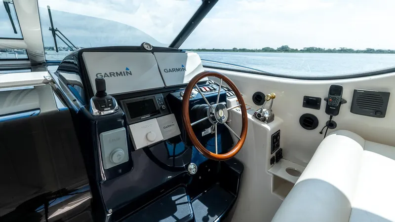  Yacht Photos Pics 2007 Tiara Yachts 4300 Sovran helm with Garmin navigation, wooden steering wheel, and modern controls.