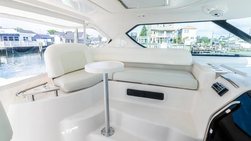  Yacht Photos Pics 2007 Tiara Yachts 4300 Sovran interior with white seating and table, dockside view.