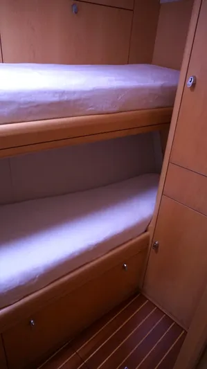 Dolce Vita Yacht Photos Pics Bunk beds in 2008 Oyster 46 yacht cabin with wooden interior.