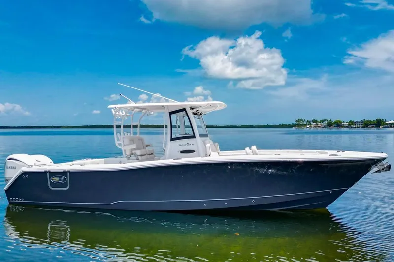  Yacht Photos Pics 2026 Sea Hunt Gamefish 30 Forward Seating boat on calm water under blue sky.