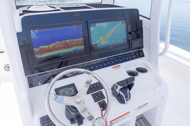  Yacht Photos Pics 2026 Sea Hunt Gamefish 30 helm with dual Garmin displays and steering wheel.