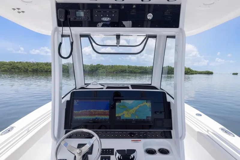  Yacht Photos Pics 2026 Sea Hunt Gamefish 30 helm with advanced navigation displays on calm water.