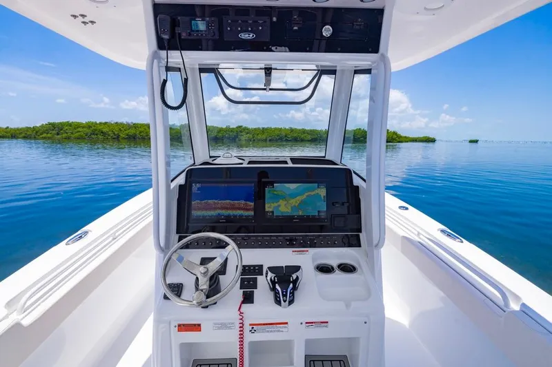  Yacht Photos Pics 2026 Sea Hunt Gamefish 30 boat dashboard with navigation screens, steering wheel, and ocean view.