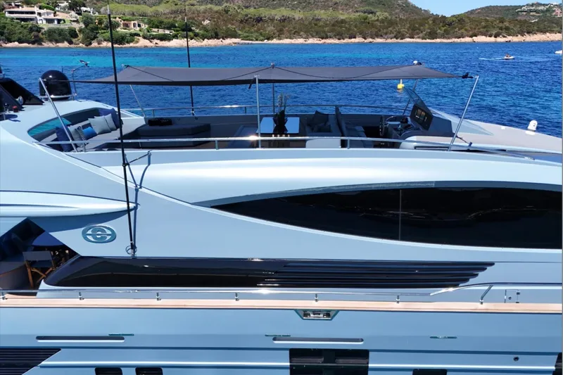 Deea II Yacht Photos Pics Luxurious 2009 Cerri Cantieri Navali 102 yacht docked in scenic coastal waters.