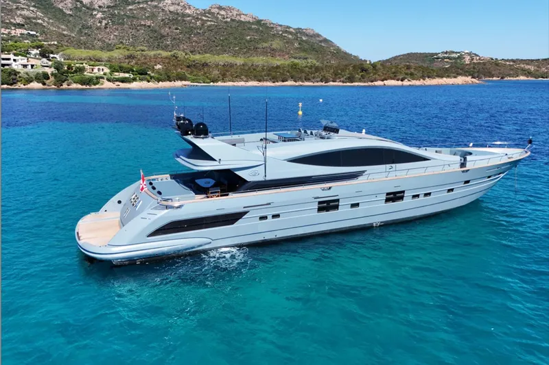 Deea II Yacht Photos Pics Luxurious 2009 Cerri Cantieri Navali 102 yacht on turquoise waters near scenic coastline.