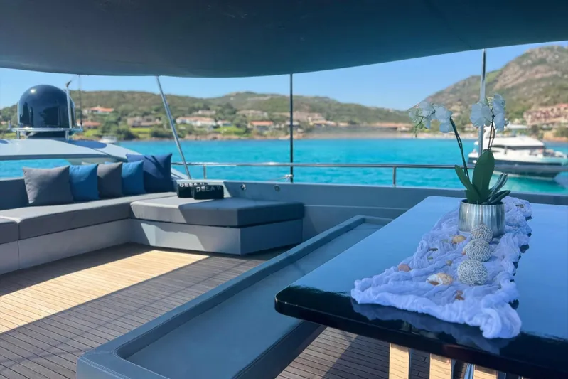 Deea II Yacht Photos Pics Luxurious 2009 Cerri Cantieri Navali 102 yacht deck with elegant seating and scenic ocean view.