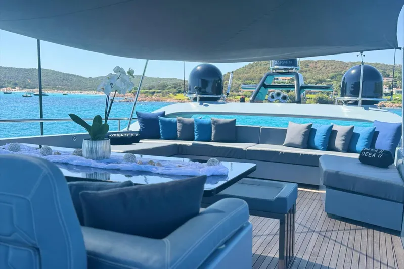 Deea II Yacht Photos Pics Luxurious deck of 2009 Cerri Cantieri Navali 102 yacht with elegant seating and scenic ocean view.