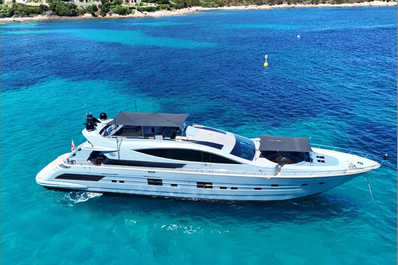 Deea II Yacht Photos Pics Luxurious 2009 Cerri Cantieri Navali 102 yacht cruising in clear blue waters.