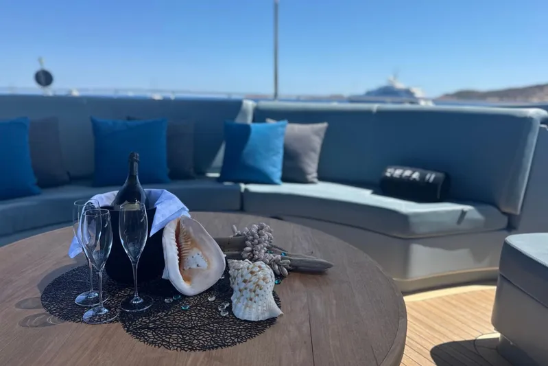 Deea II Yacht Photos Pics Luxurious deck of 2009 Cerri Cantieri Navali 102 yacht with champagne and seashells.